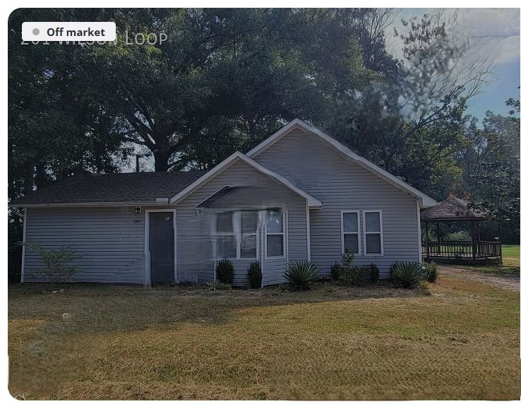 White-sided home with bay window and shaded yard