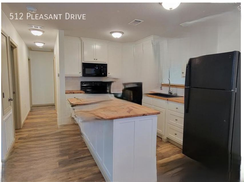 Kitchen with white cabinets and butcher block counters