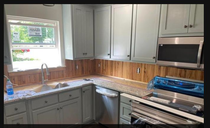 Kitchen with gray cabinets, granite counters and cedar backsplash