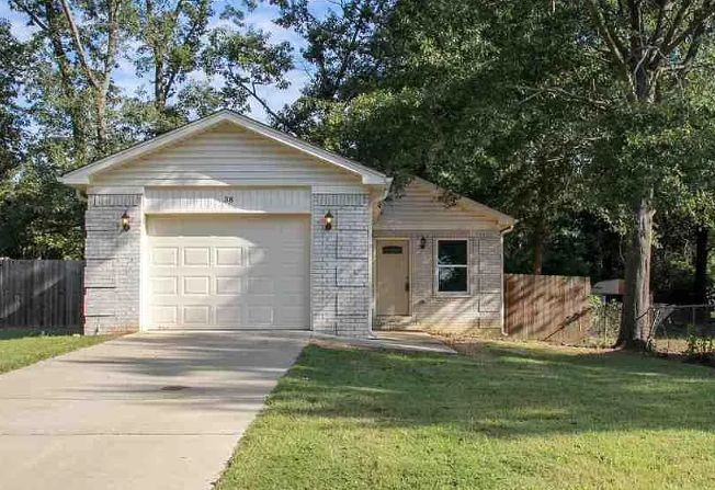 Single-story home with white brick and attached garage