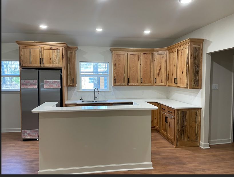 Kitchen with hickory cabinets and white quartz island