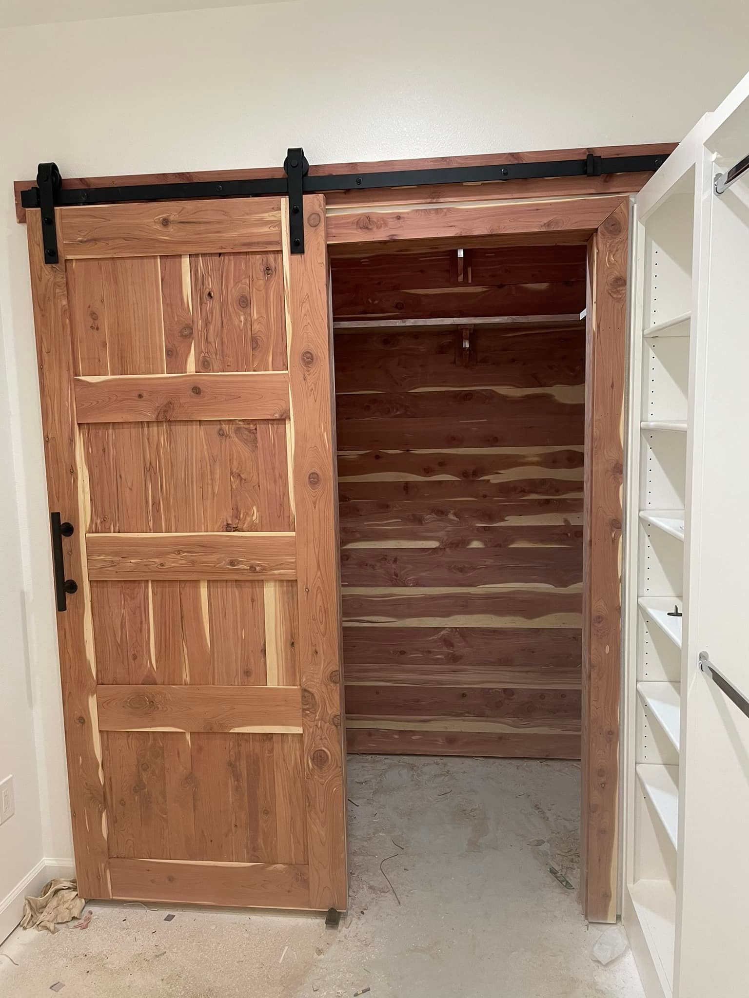 Custom cedar sliding barn door and cedar-lined closet